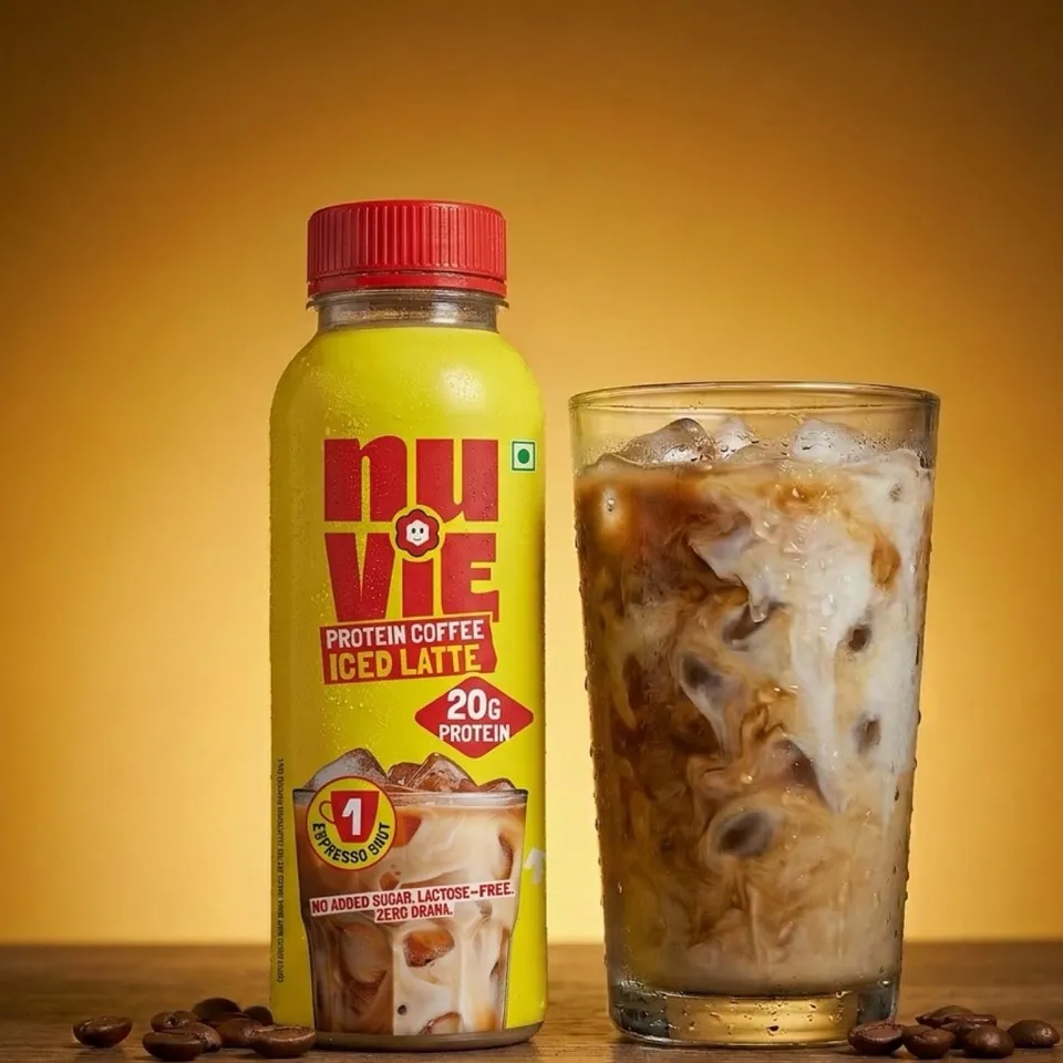 Bottle next to a glass of iced coffee